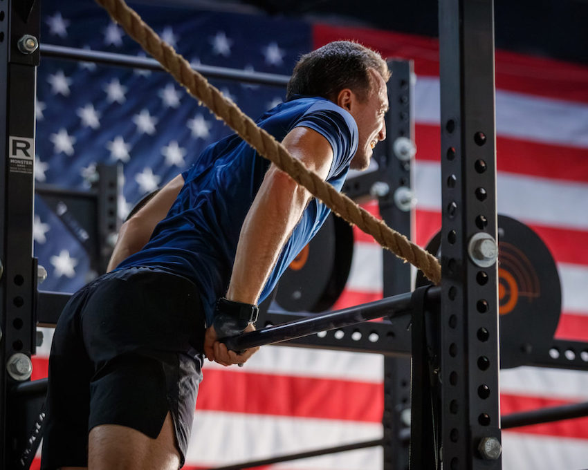 Man at the top of a bar muscle-up