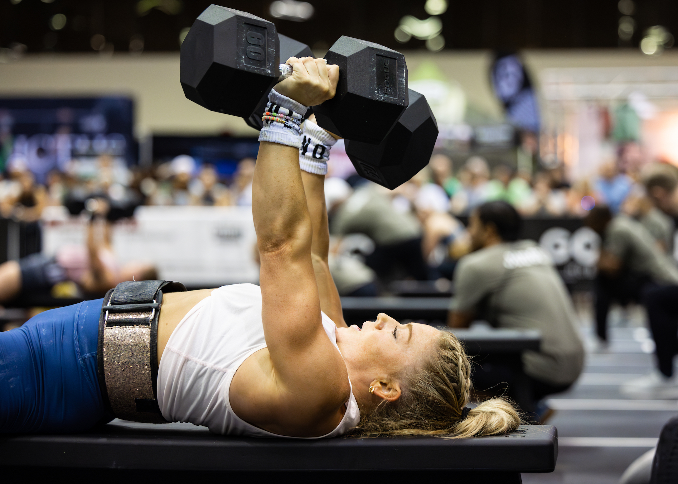 Female athlete performs dumbbell bench press