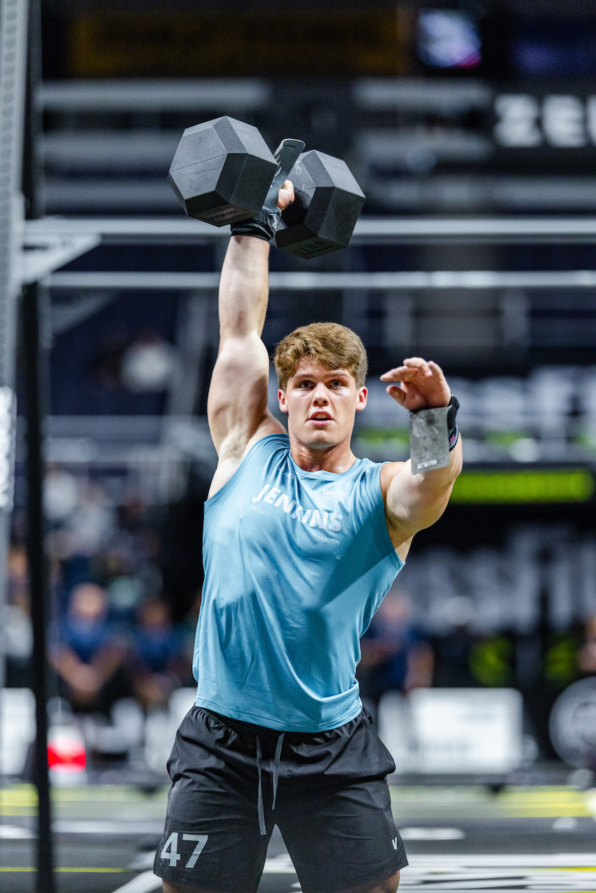 Ty Jenkins holding a dumbbell overhead during Individual Event 2