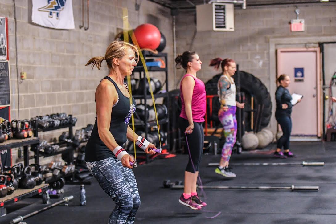 Group of athletes, all tackling double-unders