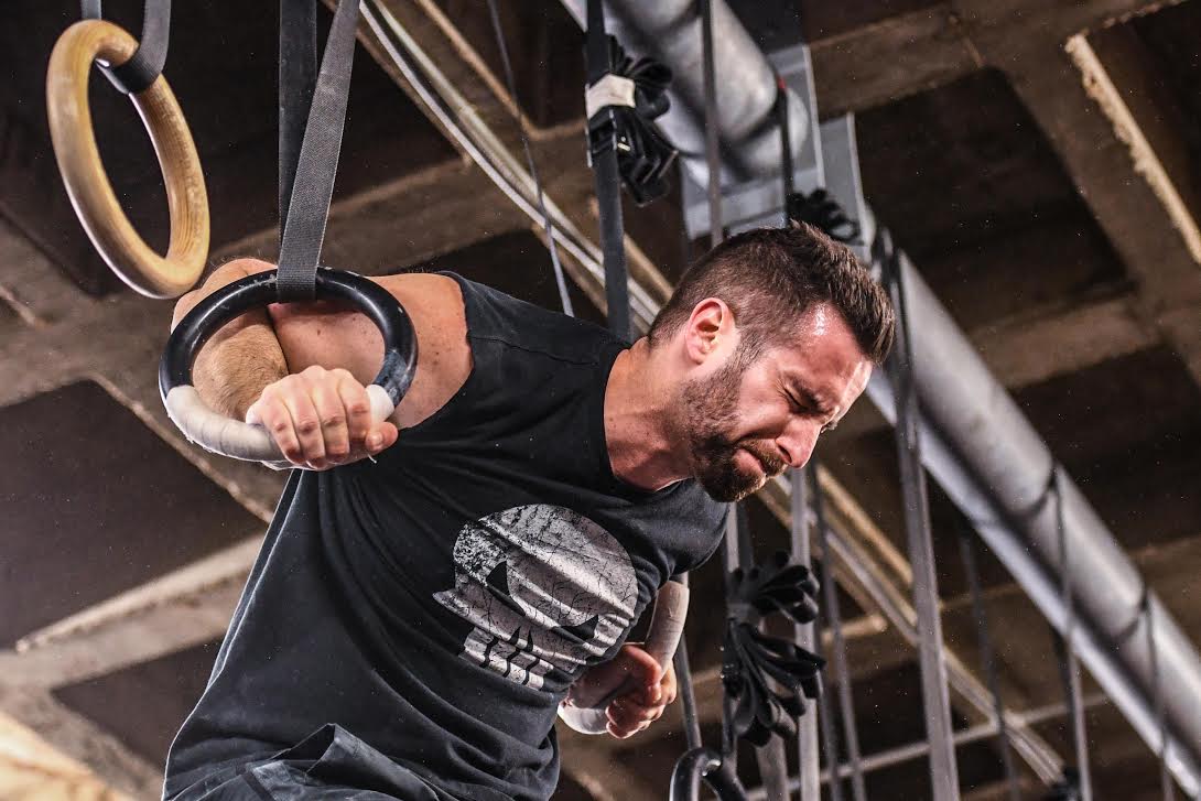 Athlete struggles through a ring muscle-up